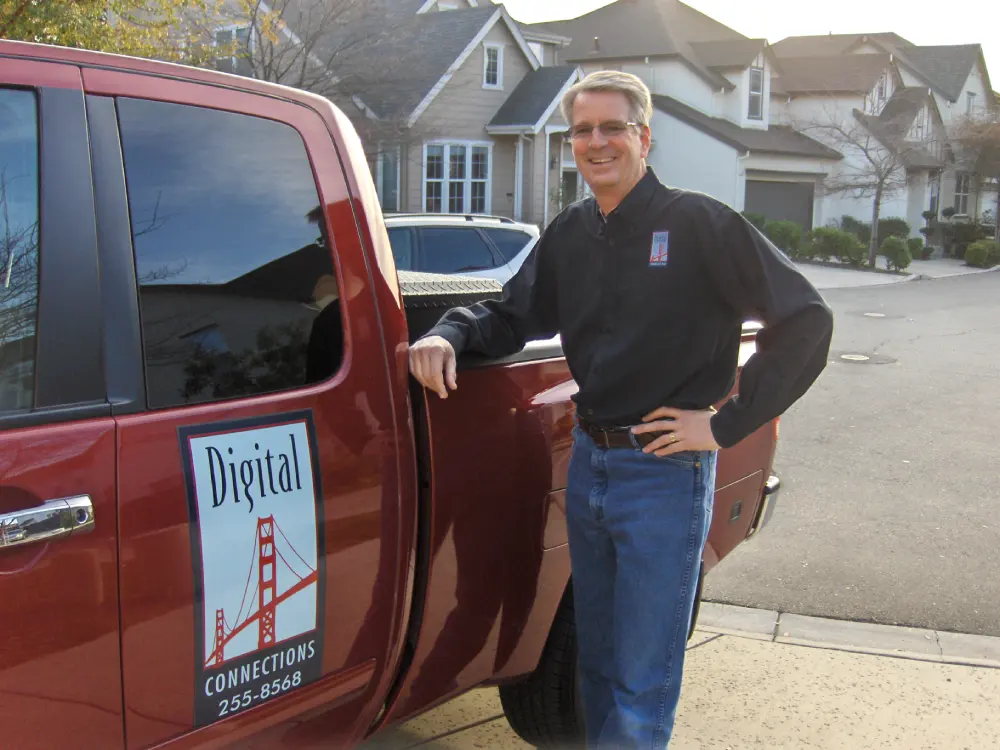 Digital Connections founder Brian Bonaccorso beside a company vehicle